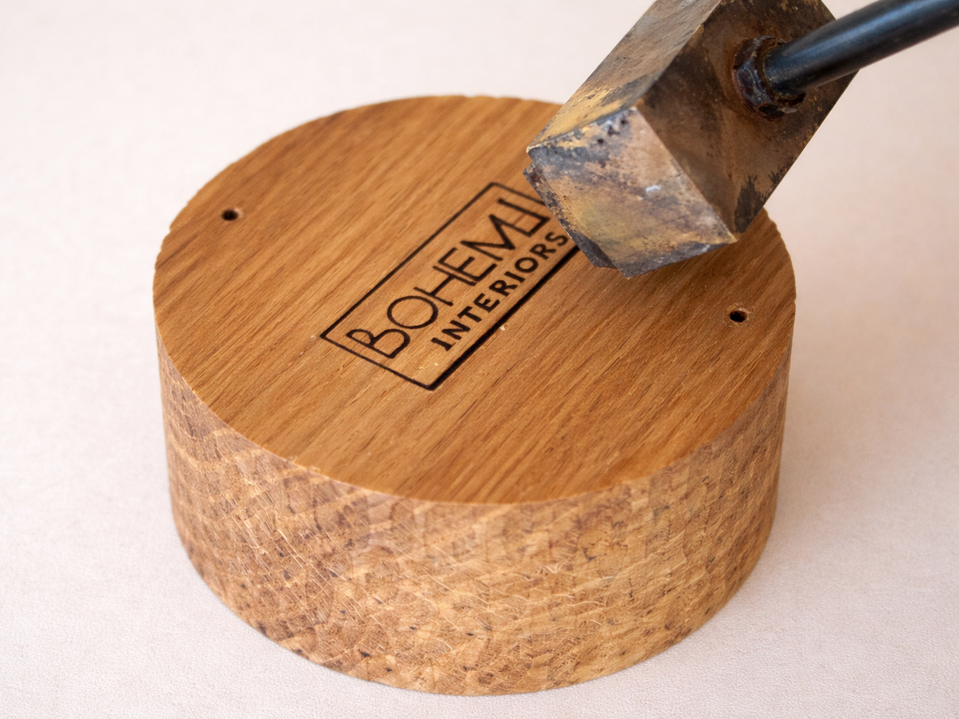 robusta candle base underside showing engraved wooden surface with logo